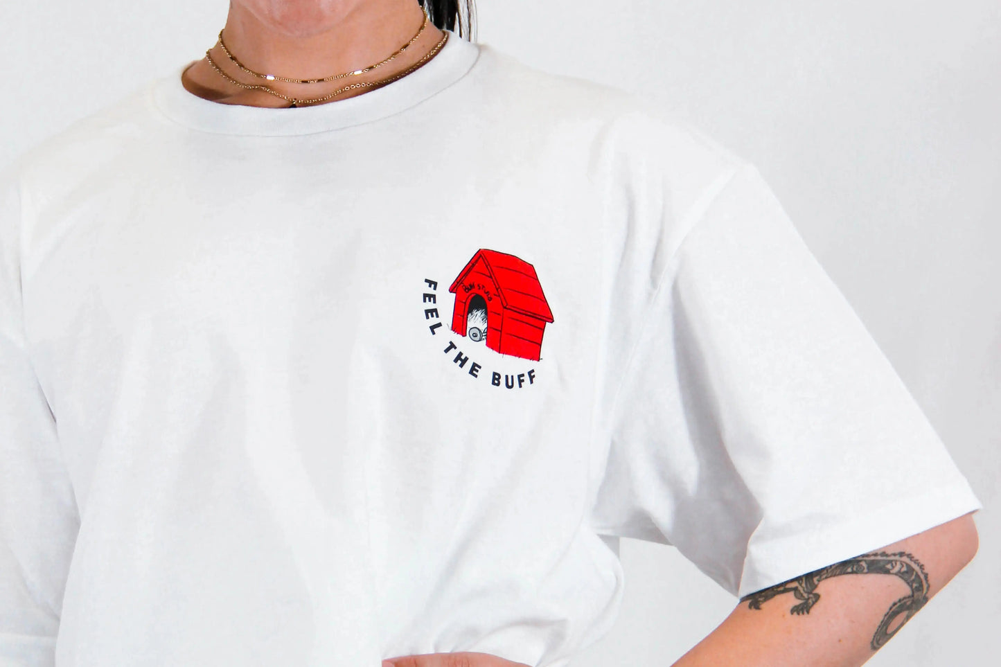 Close-up of the dog house graphic on the front of the Classic Graphic Buff Tee, part of the unique design inspired by Scoopy.