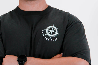 Close-up of the steering wheel graphic on the front of the Premium Buff Cover, part of the unique design inspired by Steamy-Bod Willie.