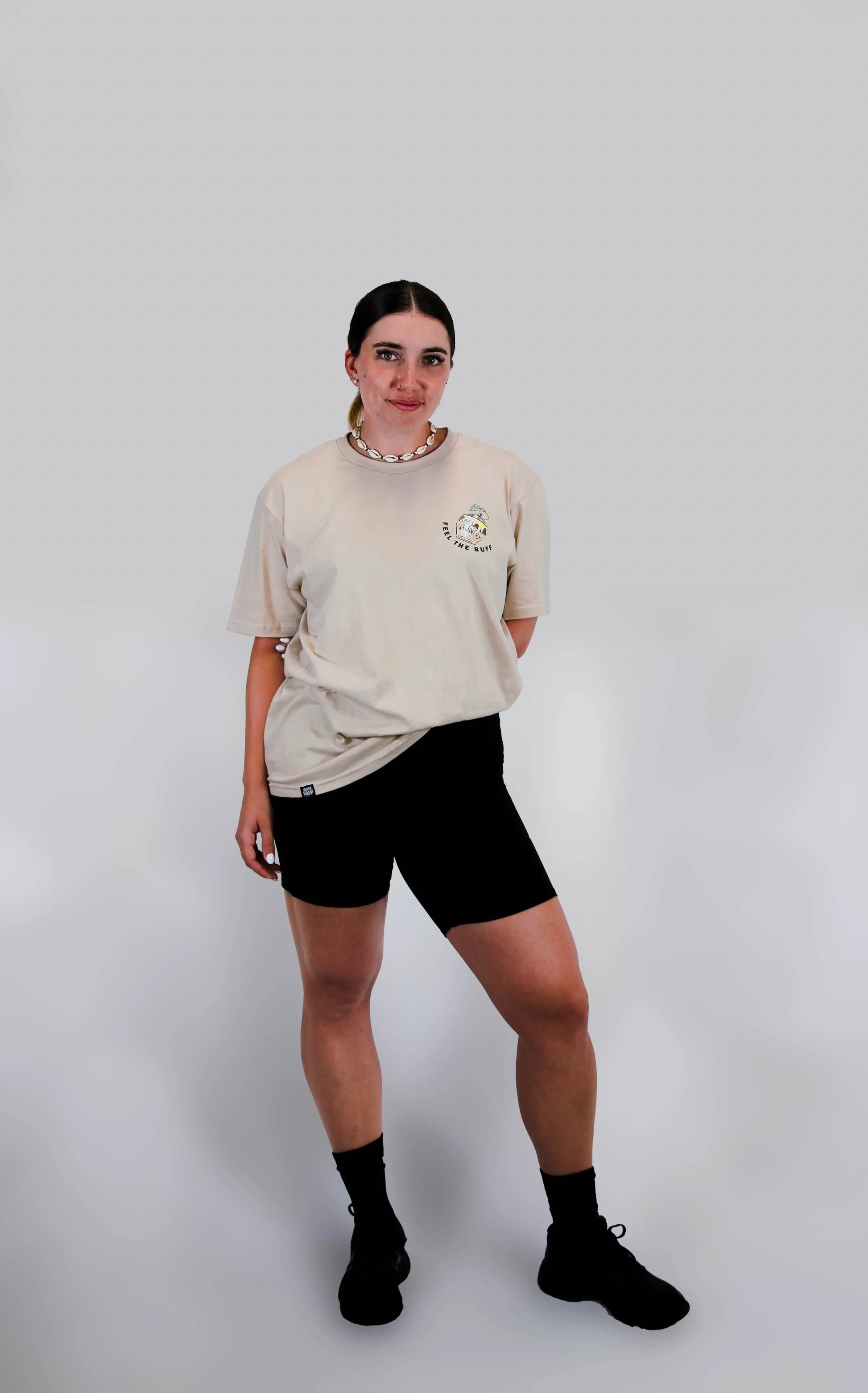 Full-body shot of a model wearing the Classic Graphic Buff Tee from the front, highlighting its versatile fit and design.