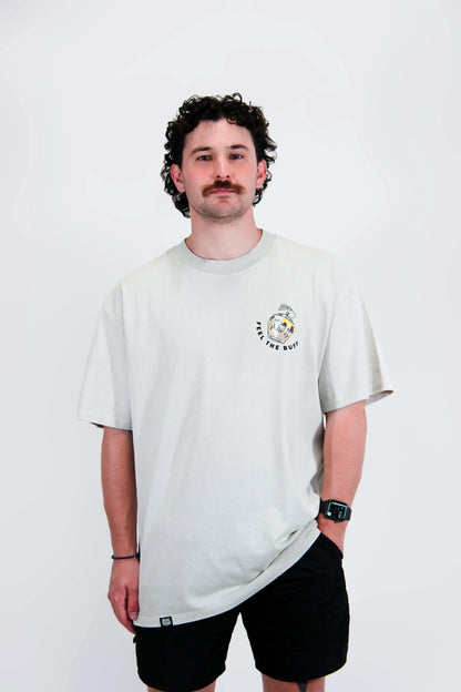 Front view of a model wearing the Premium Buff Cover, featuring a pot of Hunny graphic that complements the Winnie the Stud design on the back.